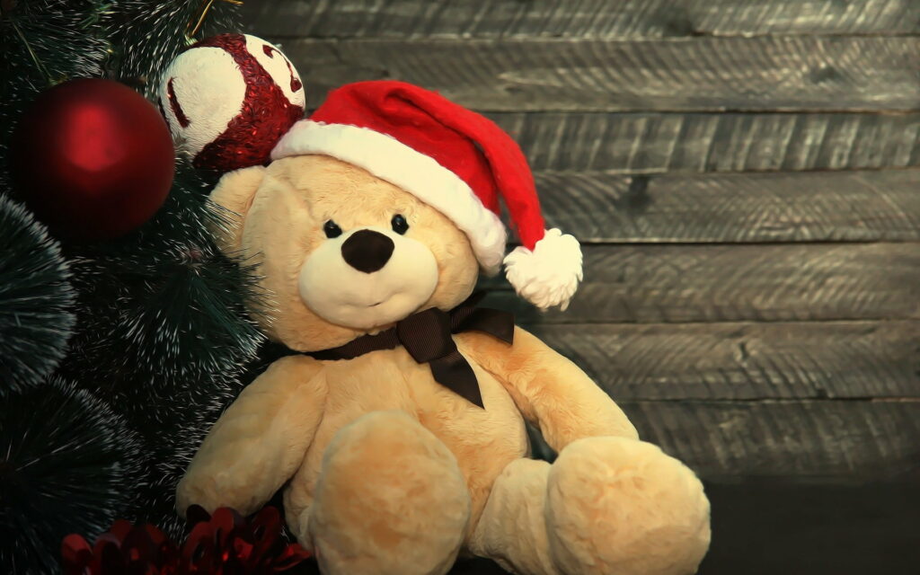 Festive Furry Friends: Welcoming the New Year with a Joyful Teddy Bear and a Dazzling Christmas Tree Wallpaper