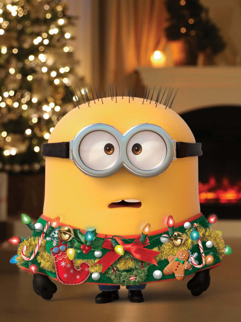 Cheerful Minion in Christmas-Themed Room with Tree & Fireplace Wallpaper