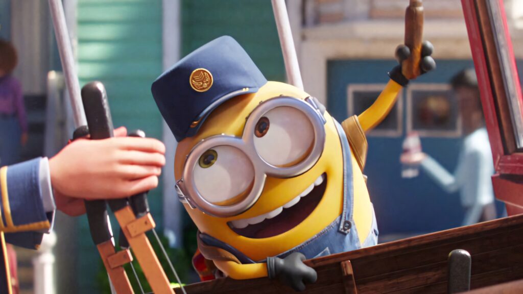 Cheerful Minion in Conductor's Hat - Fun Outdoor Wallpaper