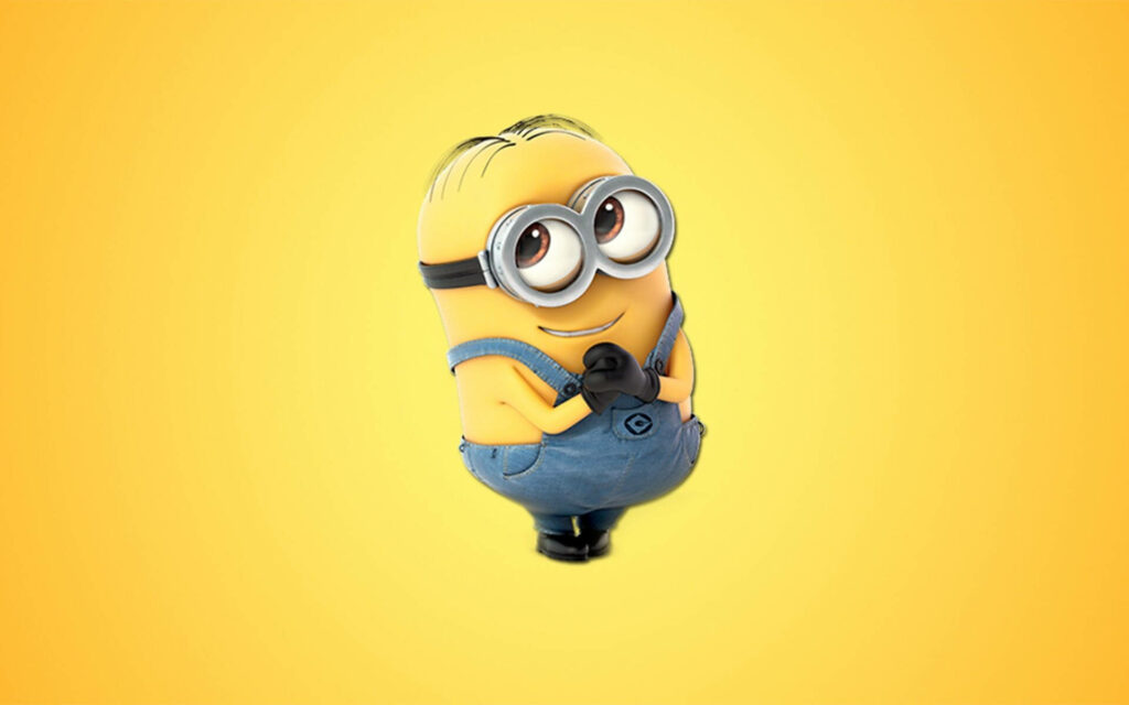 Cheerful Minion in Blue Overalls: Vibrant Yellow Wallpaper Background