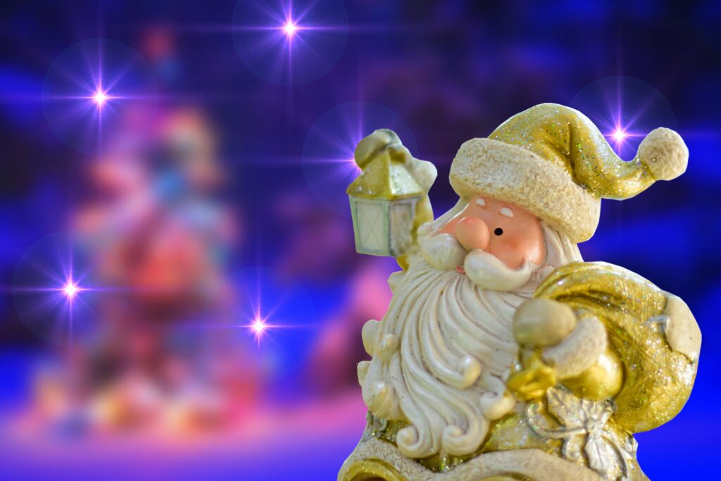 Cheerful Santa Claus Figurine with Lantern in Starry Background Wallpaper