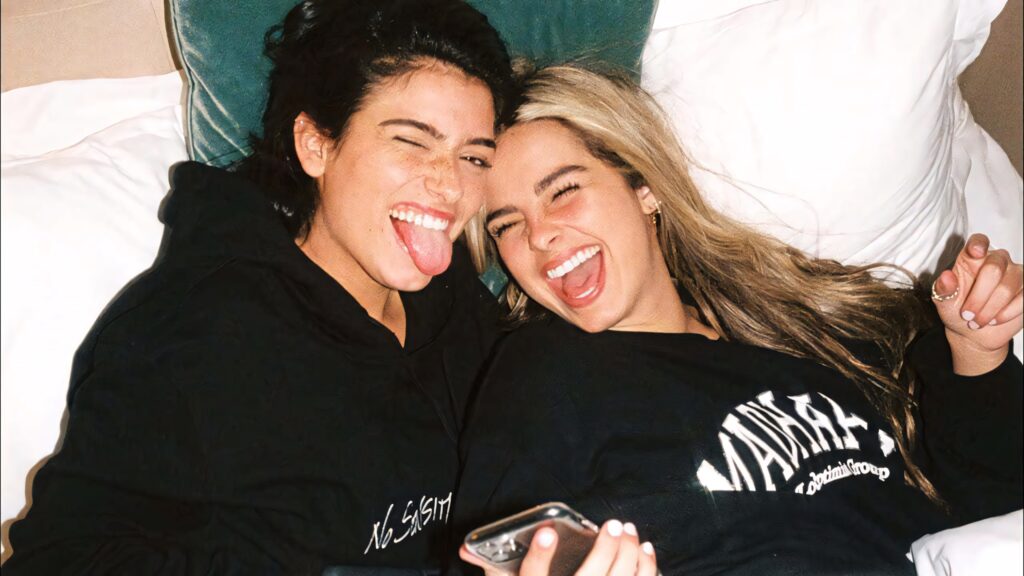 Cheerful Wallpaper of Charli D'Amelio & Addison Rae Sharing Friendship