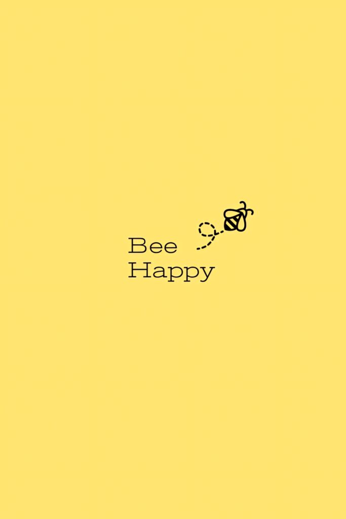 Cheerful yellow wallpaper with bee illustration and motivational Bee Happy text background