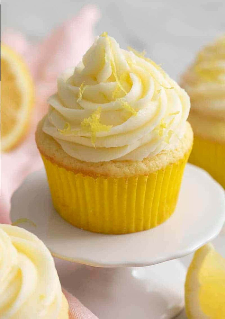 Cheerful Yellow Cupcake with Creamy Frosting & Lemon Zest Wallpaper