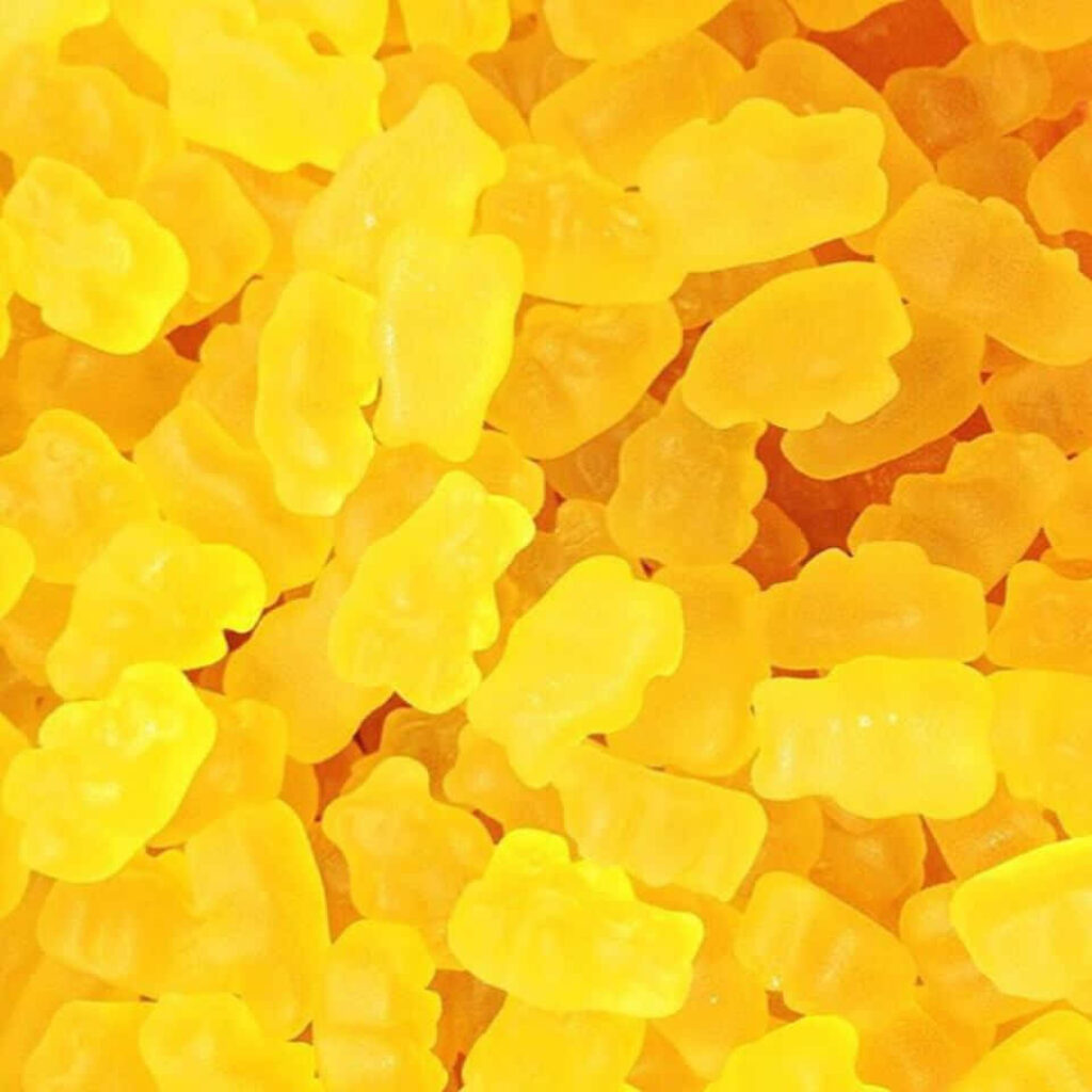 Bright Yellow Gummy Bears Wallpaper: Cheerful Candy-Themed Background