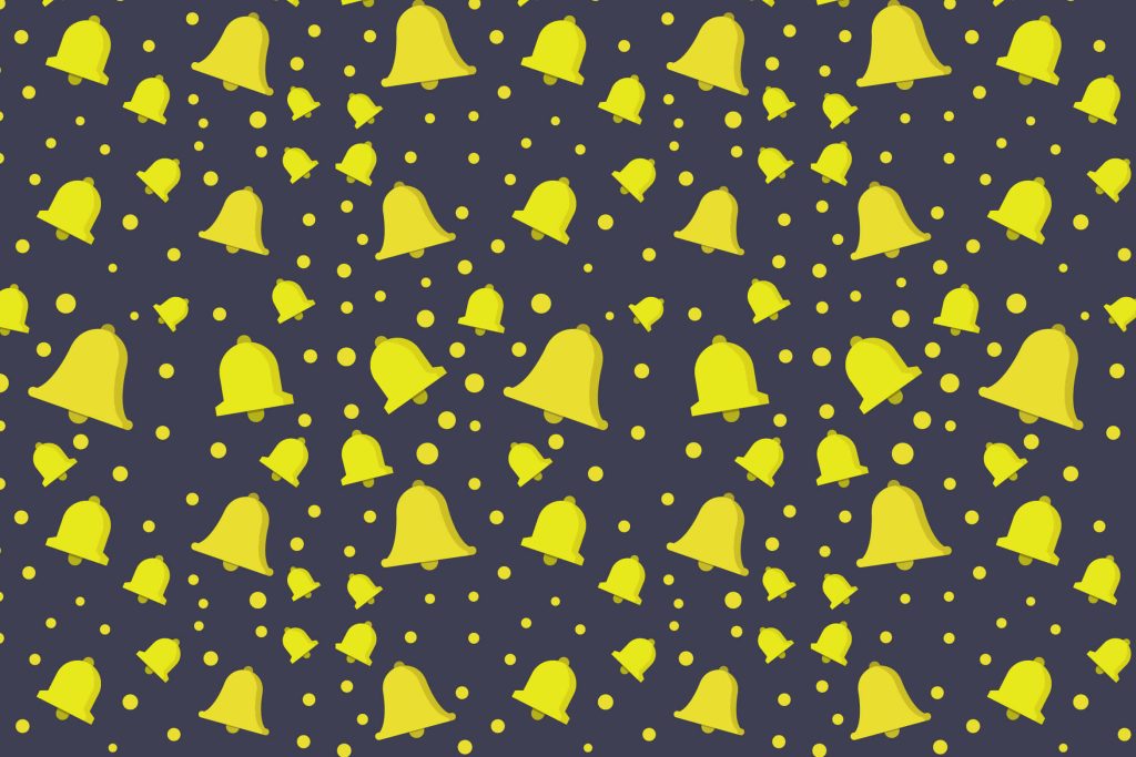 Minimalist festive wallpaper with bright yellow handbells and polka dots on charcoal background