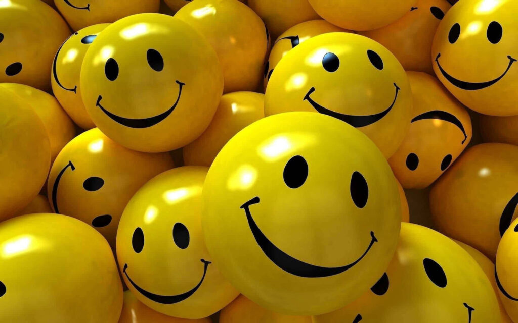 Cheerful Yellow Smiley Face Wallpaper for a Fun Atmosphere