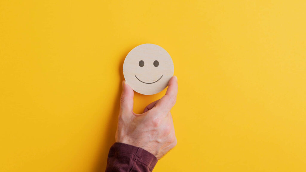 Cheery Charm: Wooden Circle with Smiling Face Wallpaper