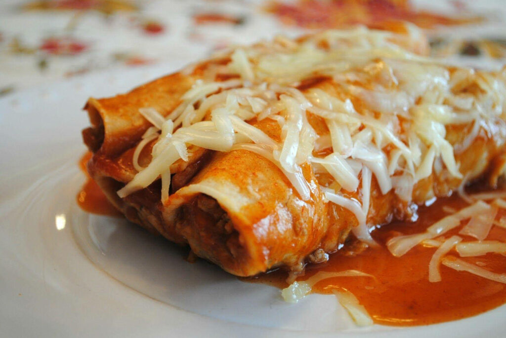 Cheesy Enchiladas Close-Up: Mouthwatering Wallpaper Background