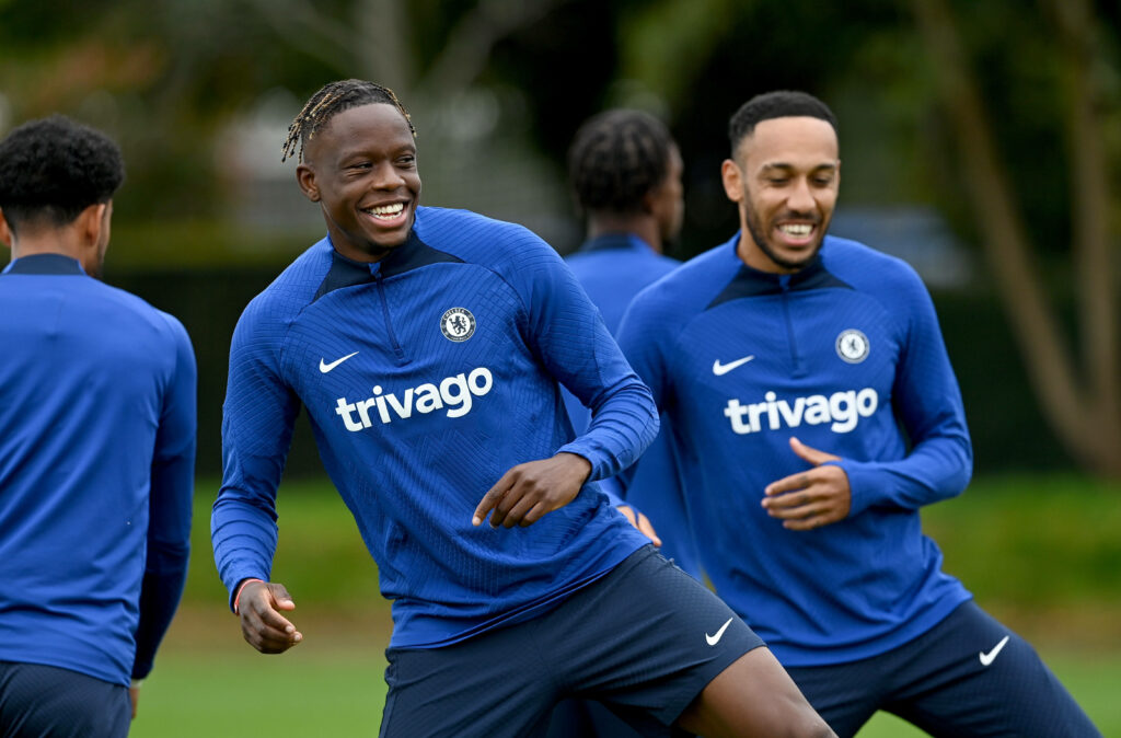 Chelsea FC players Aubameyang and Zakaria smiling during blue training session with team logo Wallpaper