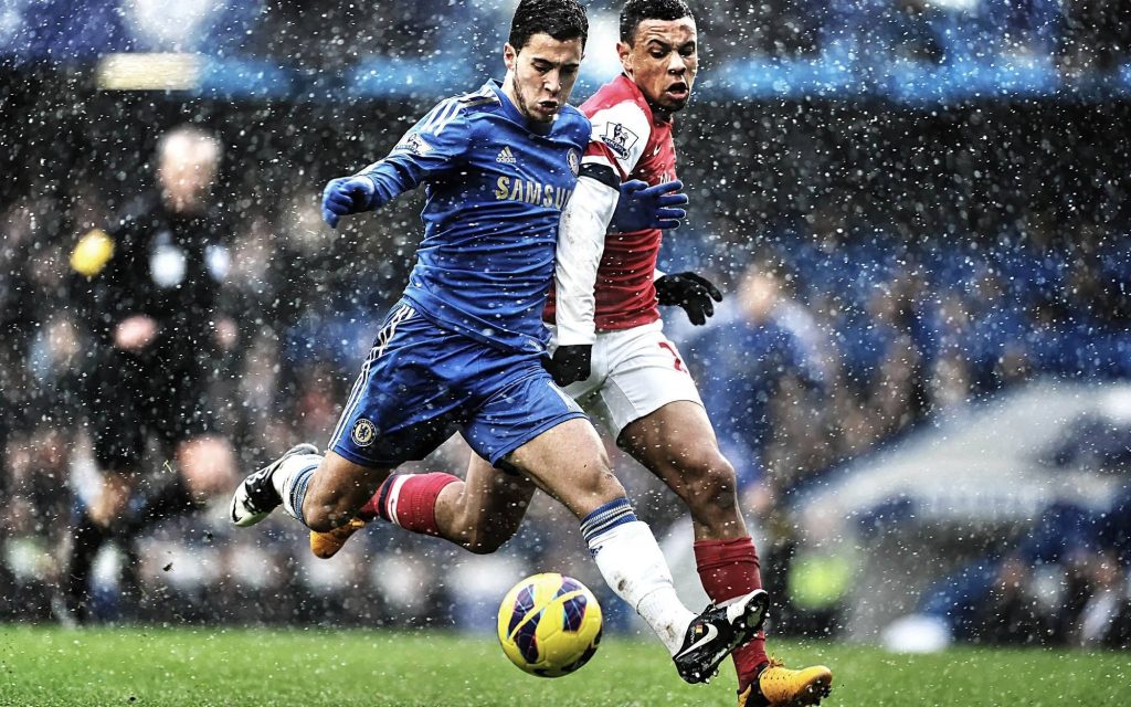 Chelsea’s Eden Hazard and Arsenal’s Kieran Gibbs in intense Premier League soccer match action Wallpaper