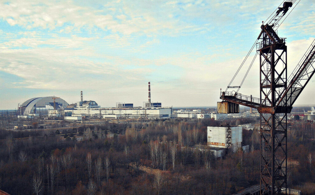 Chernobyl abandoned industrial site with rusted crane decaying structures and cloudy sky wallpaper