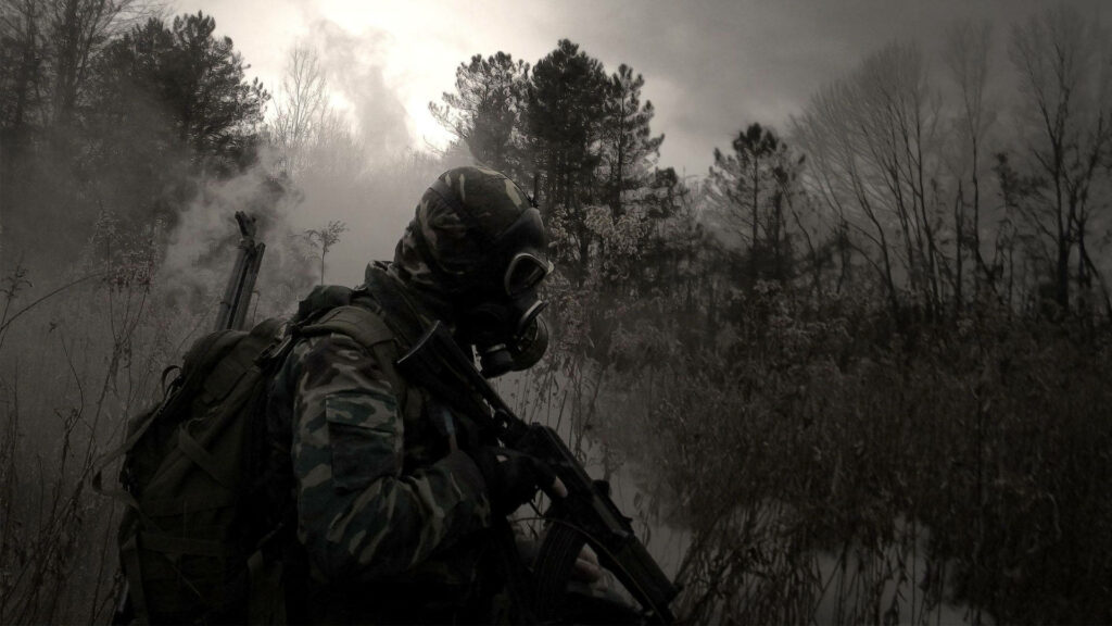 Military guard in camouflage and gas mask patrols misty Chernobyl forest winter trees wallpaper