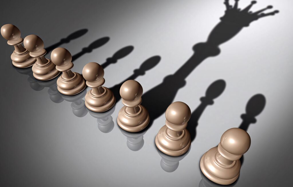 Chess pawns with one shadow transforming into a queen symbolizing growth ambition and potential wallpaper