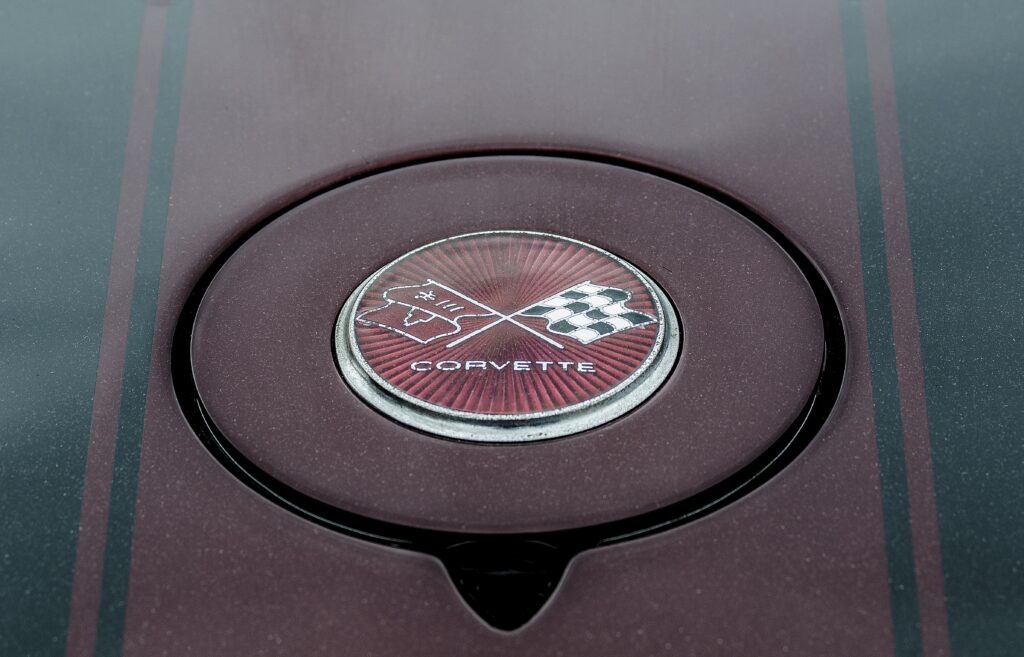 Close-Up Chevrolet Corvette Logo Wallpaper on Metallic Surface