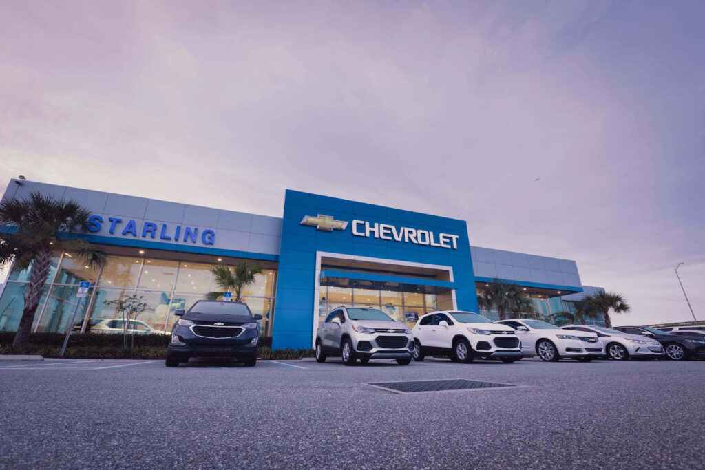 Stunning Chevrolet Dealership Wallpaper with Iconic Impala at Dusk