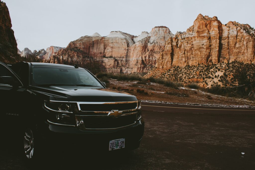 Chevrolet SUV Front View: Adventure Against Majestic Rock Formations Wallpaper