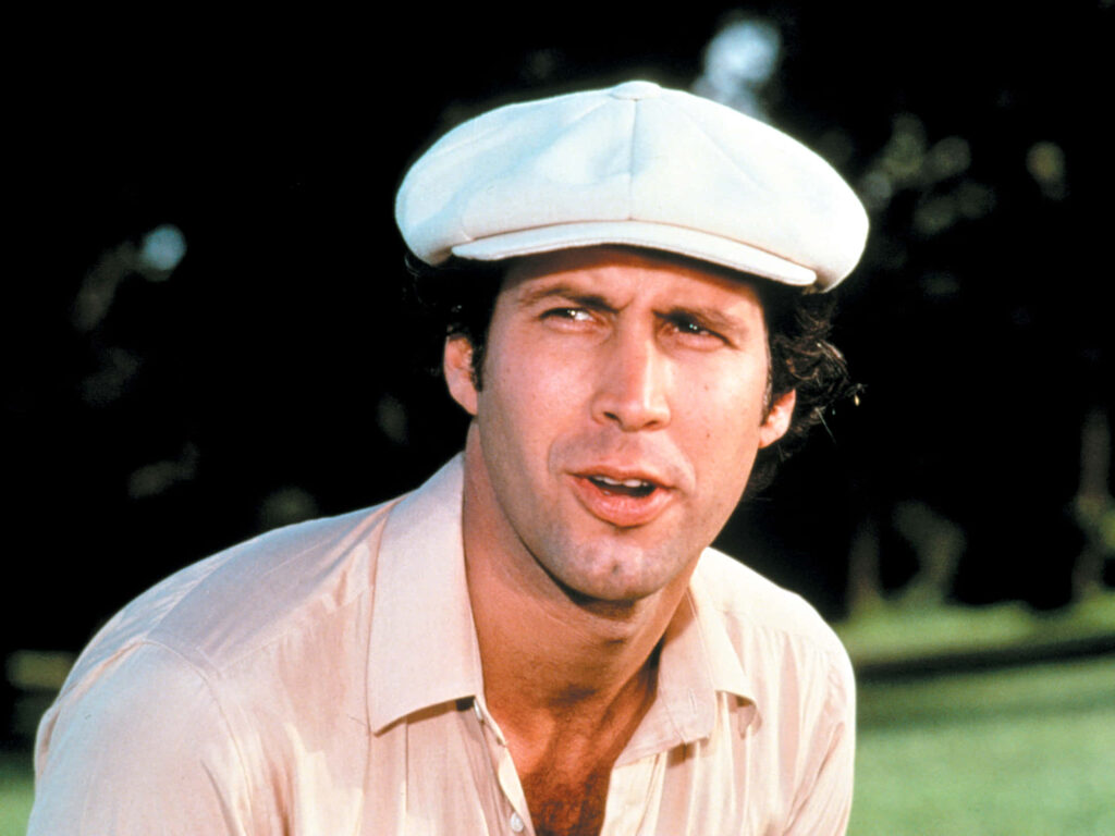Chevy Chase outdoor wallpaper wearing light cap and shirt with soft natural lighting background