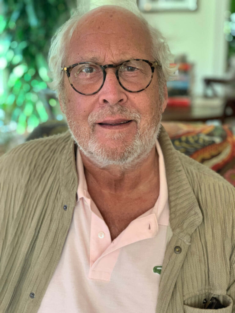 Chevy Chase relaxed indoors soft natural light cozy home decor greenery wallpaper background