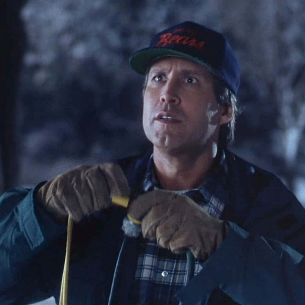 Chevy Chase classic winter scene plaid shirt jacket cap nostalgic comedic cinematic wallpaper