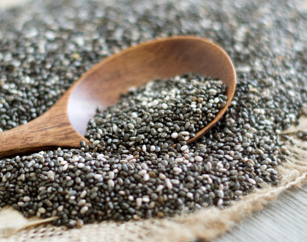 Chia Seeds Close-Up: Textured Wooden Spoon Wallpaper Background