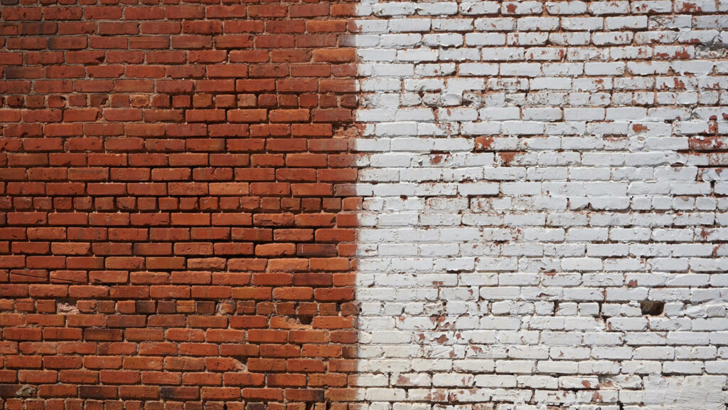 Split-design brick wallpaper with red-brown and distressed white bricks for rustic urban decor