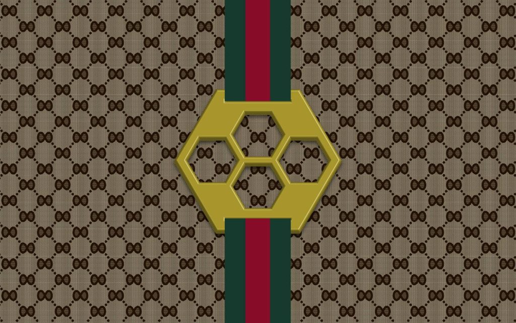 Chic Gucci wallpaper with GG monogram canvas green red stripe and gold hexagonal emblem background