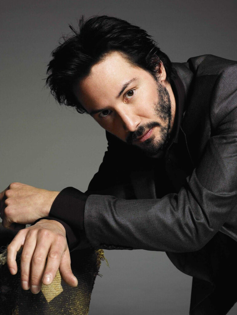 Elegant Keanu Reeves Wallpaper: Charismatic Pose in Dark Suit