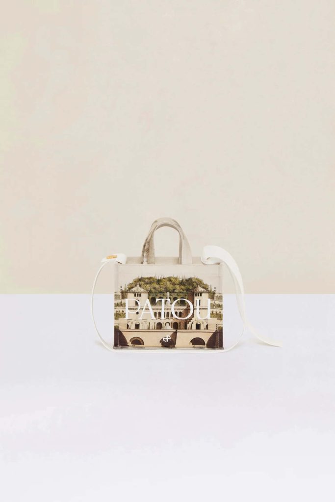Chic wallpaper with Patou tote bag featuring architectural print and bold white logo on neutral background