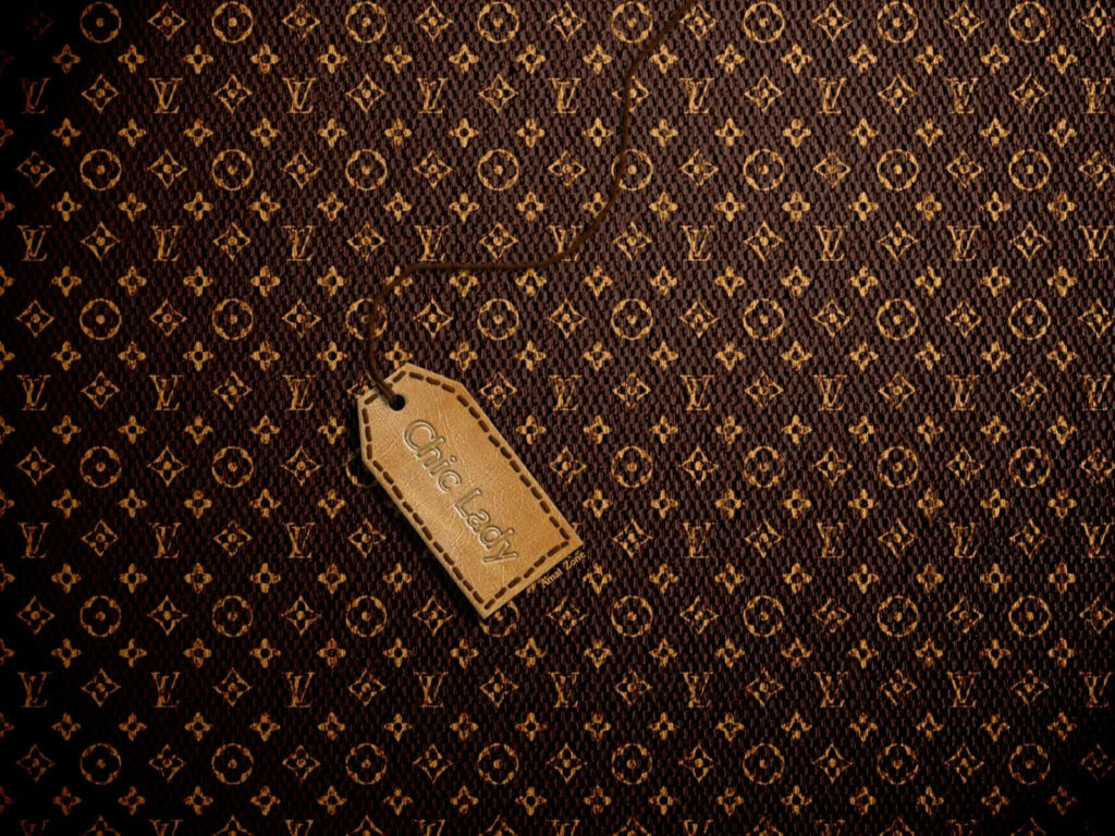 Chic Heritage: Vintage Louis Vuitton Wallpaper with Leather Tag Accent on Rough Surface