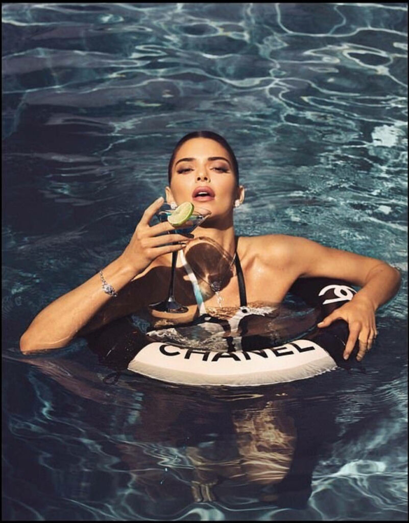 Kendall Jenner Poolside Wallpaper: Elegance with Chanel Float