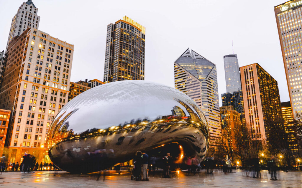 Cloud Gate sculpture reflecting Chicago skyscrapers at dusk vibrant cityscape wallpaper background