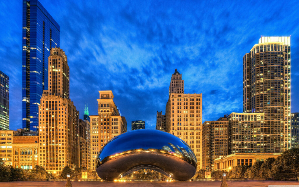 Chicago skyline reflected in Cloud Gate Bean sculpture with illuminated skyscrapers wallpaper