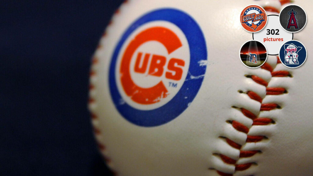 Close-up of official Chicago Cubs baseball showing red stitching and bold blue red logo Wallpaper