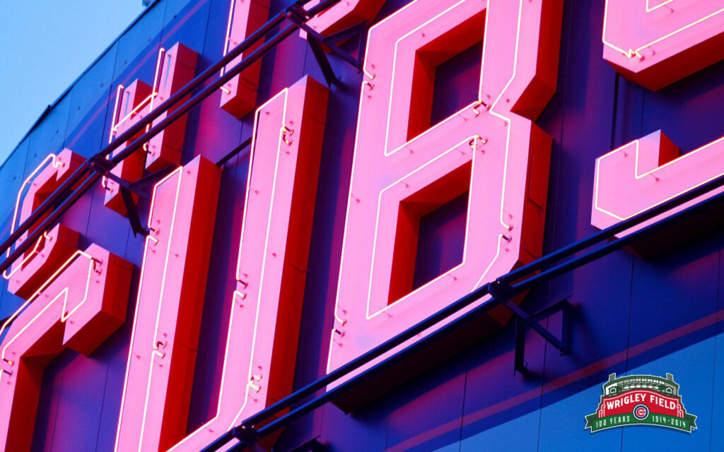 Close-up vibrant Chicago Cubs neon sign Wrigley Field red pink hues baseball atmosphere wallpaper