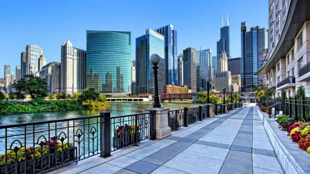 Chicago riverside walkway with glass skyscrapers flowers iron railings urban cityscape wallpaper