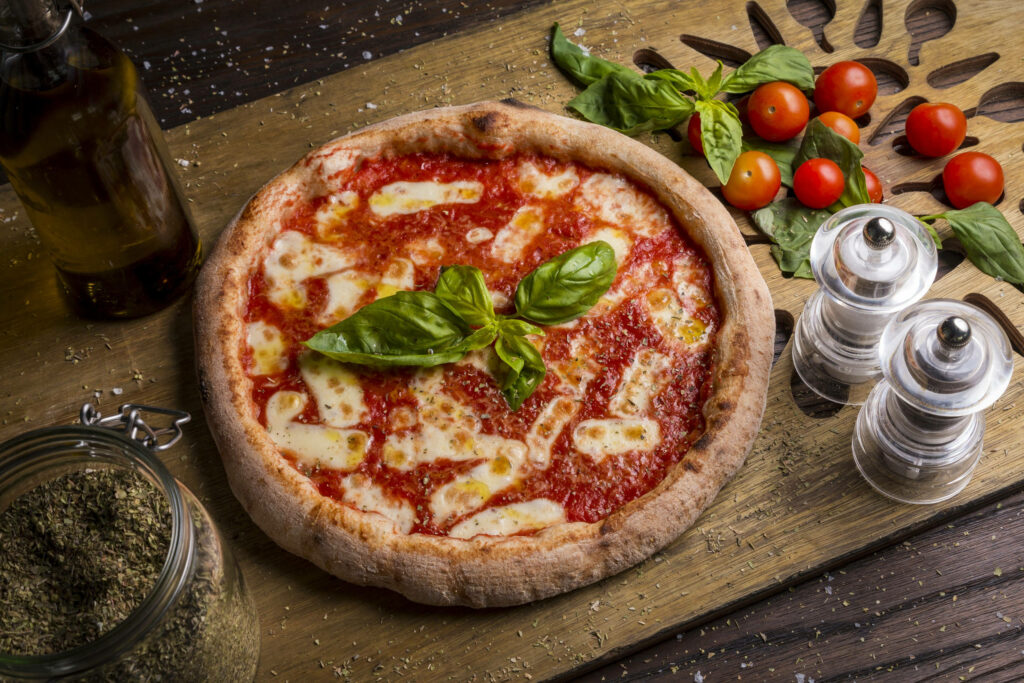 Chicago-style pizza with melted cheese fresh basil and tomato sauce surrounded by fresh ingredients Wallpaper
