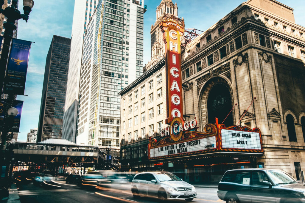 Chicago Theater marquee with vibrant skyscraper skyline time lapse urban wallpaper background