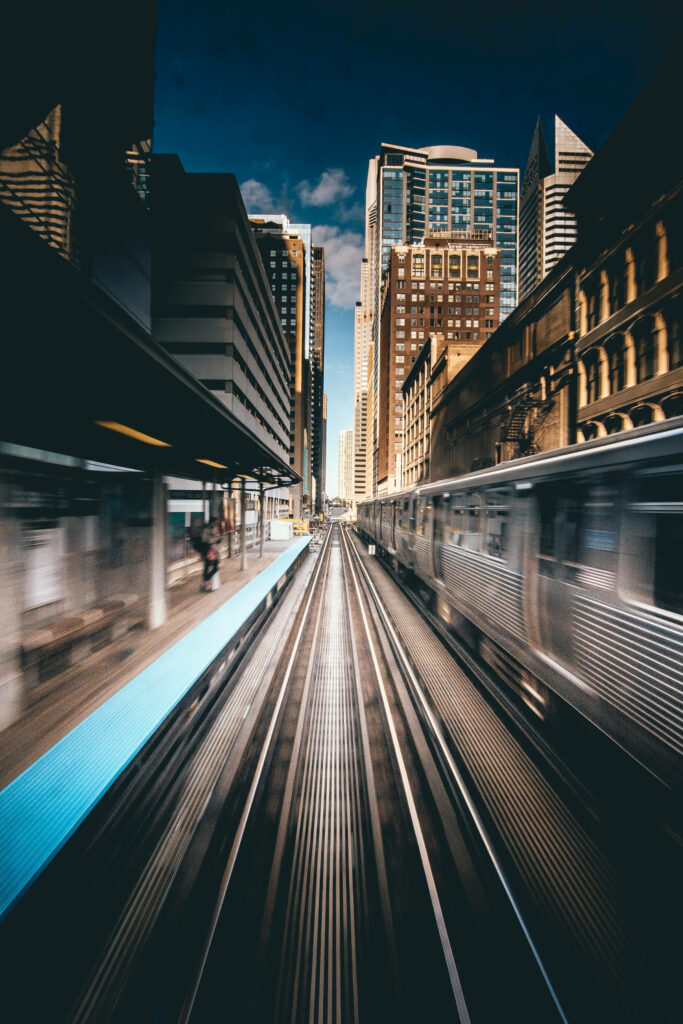 Time-lapse view of Chicago train station with speeding trains vibrant blue platforms and skyline Wallpaper