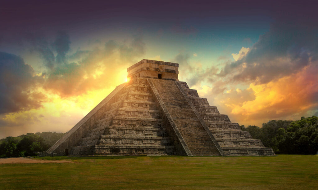 Chichen Itza pyramid at sunset with golden light and lush greenery ancient Mayan landmark wallpaper