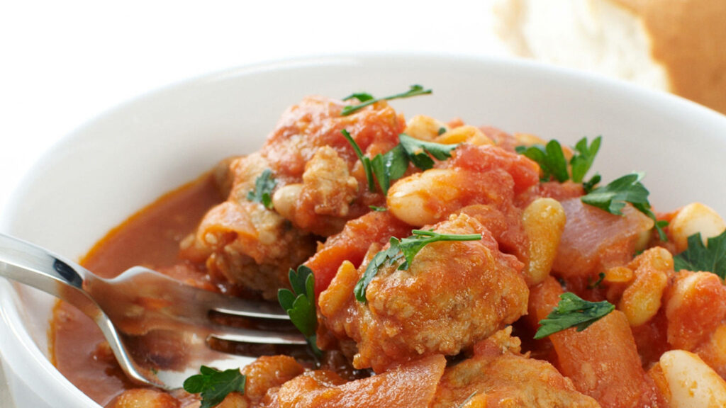 Stunning Close-Up of Chicken Cassoulet: Classic French Dish Wallpaper