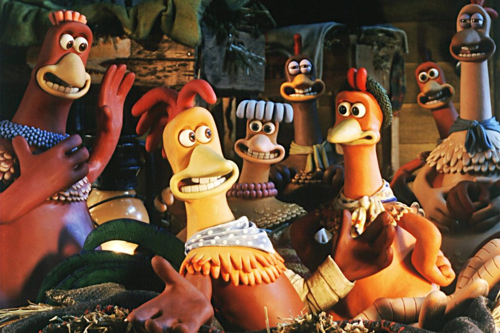 Chicken Run wallpaper featuring Ginger and flock in rustic barn with warm stop-motion lighting