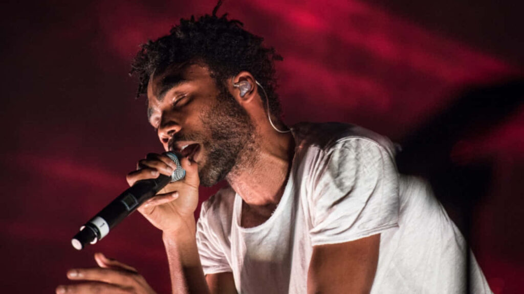 Childish Gambino Live: Energetic Wallpaper with Vibrant Red Backdrop