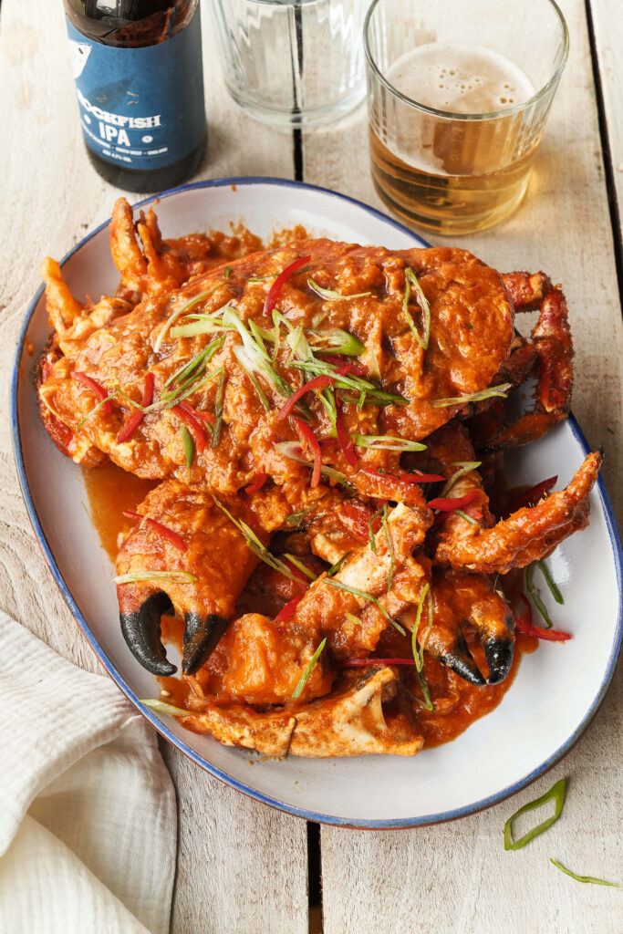 Mouthwatering Chili Crab Wallpaper with Beer on Rustic Table