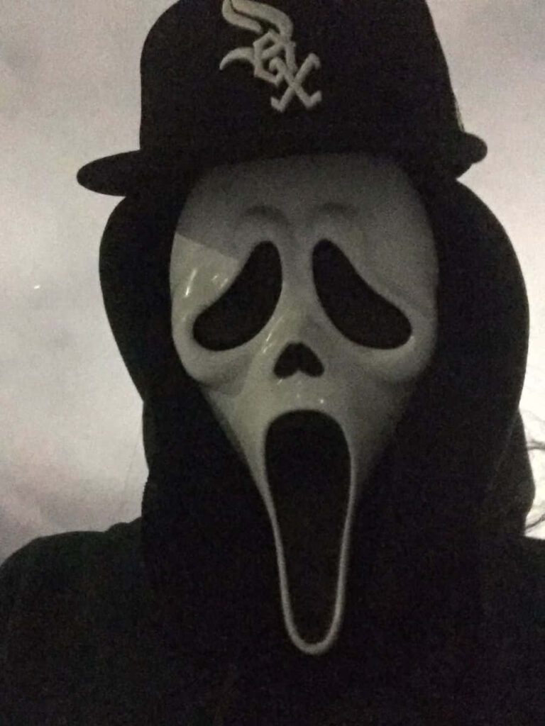 Scream Ghostface: Chillingly Iconic and Intense Wallpaper Depicting the Infamous Masked Figure Sporting a Sox Baseball Cap in Striking Black-and-White