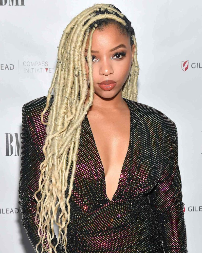 Chloe Bailey portrait with long blonde faux locs sparkling black top trendsetting braids 2022 Wallpaper