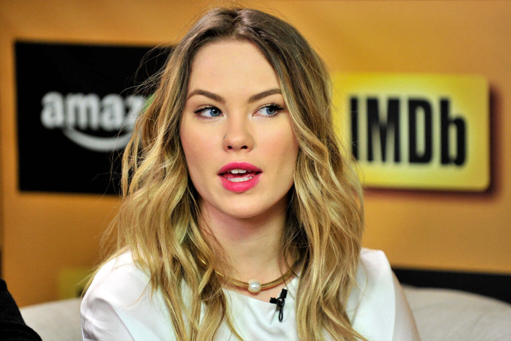 Chloe Rose with wavy blonde hair in white outfit warm background Amazon IMDb logos wallpaper