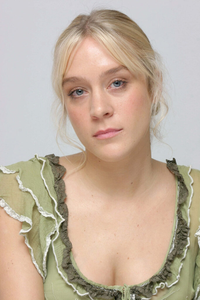 Chloë Sevigny in soft green ruffled top against light background with serene pastel tones Wallpaper