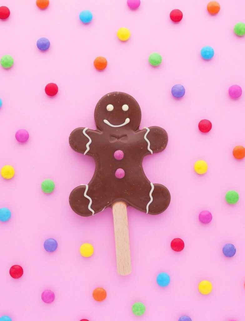 Colorful Chocolate Gingerbread Dessert Wallpaper on Pastel Pink