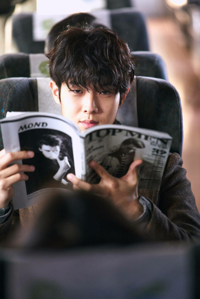 Choi Woo-shik reading magazine on train natural light calm introspective cinematic wallpaper background